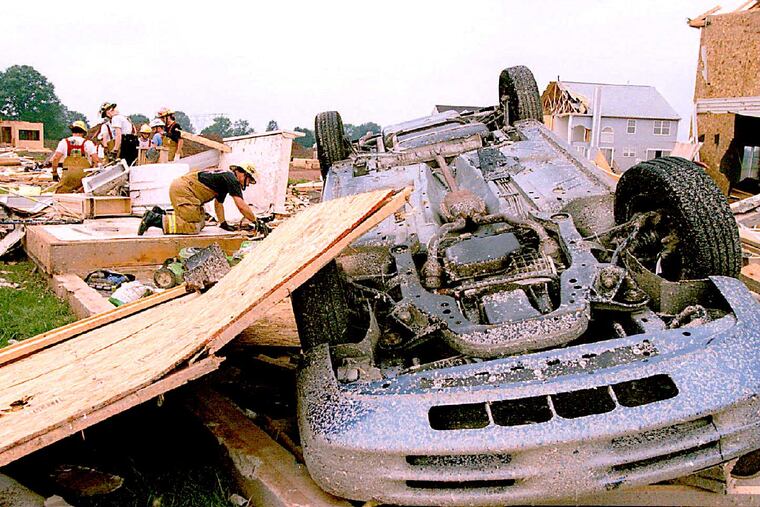 SOURCE CAPTION: Torn, Akira Suwa, City, Preg, 7/28/94; Tornado damage in Limerick Twp.;Local fire fighters are shifting through the debris of destroyed house at The Hamlet development. PHOTOGRAPHER: Akira Suwa - SHOOT DATE: Jul 27, 1994