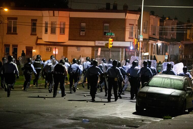 Police move forward on Chestnut St. toward 53rd Street on Oct. 26, 2020.