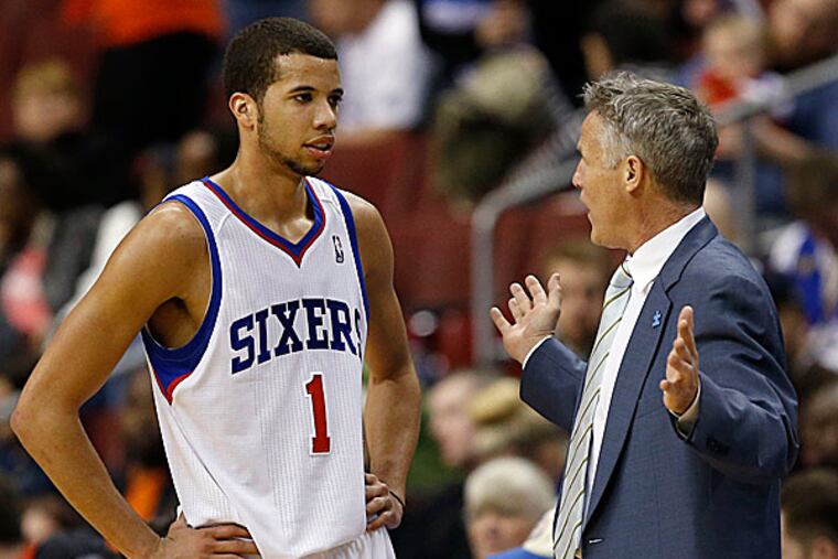 Sixers point guard Michael Carter-Williams and head coach Brett Brown. (Yong Kim/Staff Photographer)