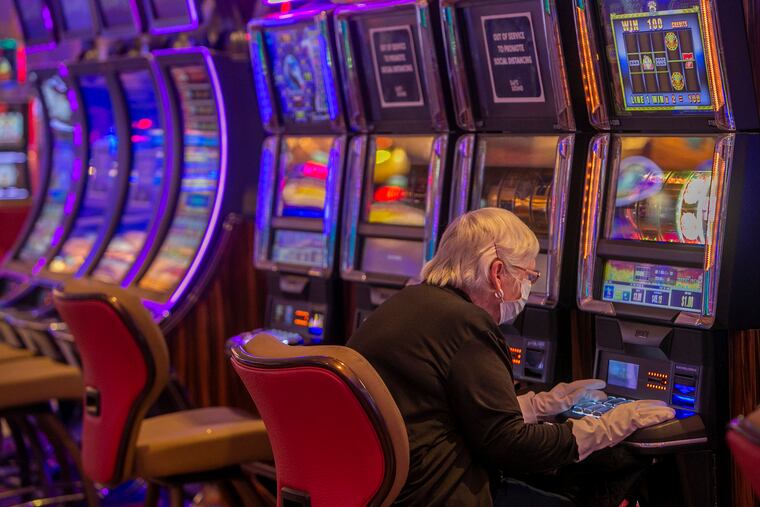 Susan Longacre of Cape May, came prepared with mask and gloves to play machines on opening of Hard Rock Casino in Atlantic City. This is the first day the casino has been open since the COVID-19 pandemic shutdown.