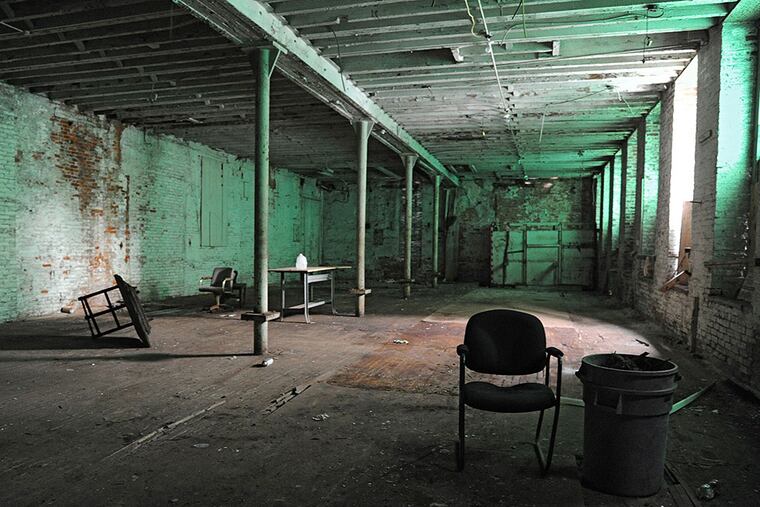 This four-story building at 1101 Frankford Ave. is supposed to be sealed, but two recent visits found it open. Its owners say their plans are advancing. CLEM MURRAY / Staff Photographer