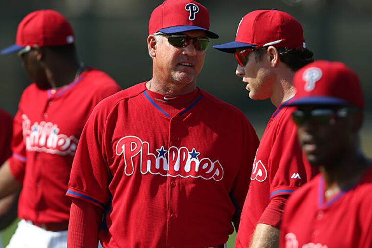Phillies manager Ryne Sandberg talks to Chase Utley. (David Maialetti/Staff Photographer)