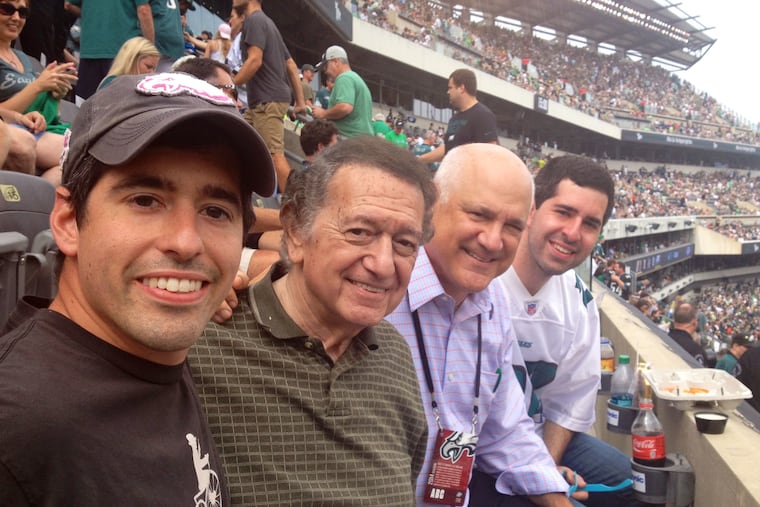 Physician Theodore Macnow (left) author of a new concussion study, joined grandfather Marvin Macnow, father and WIP radio host Glen Macnow, and brother Alex Macnow (also a physician) at an Eagles game in 2019.