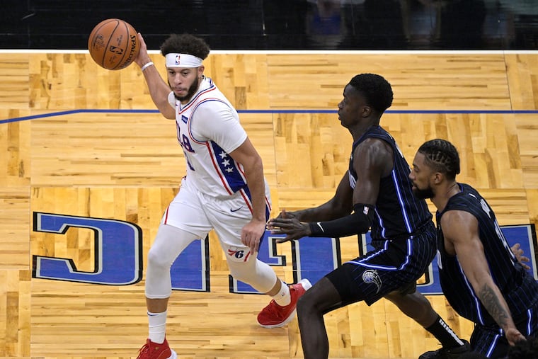 Seth Curry (left) sets up a play in front of Magic guard Dwayne Bacon and center Khem Birch (right). Curry had 21 points on Thursday night.