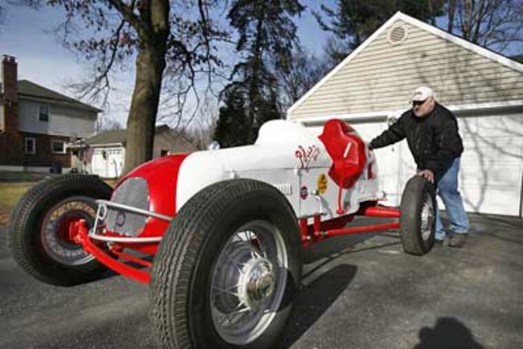 Paul Cavaliere pushes a replica of a 1930's race car that he built out of his Warrington, Pa. garage. (Eric Mencher/Staff Photographer)