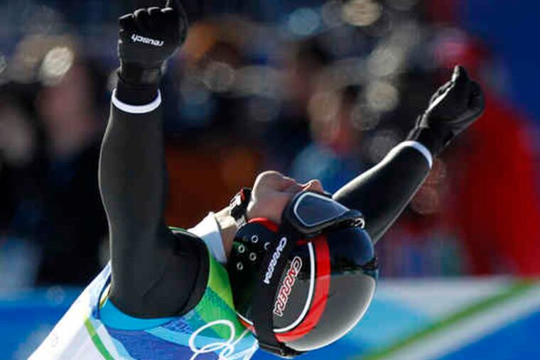 Switzerland's Simon Ammann celebrates winning the gold medal in the men's large-hill ski-jumping competition. He is the first ski-jumper to win four individual Olympic gold medals.