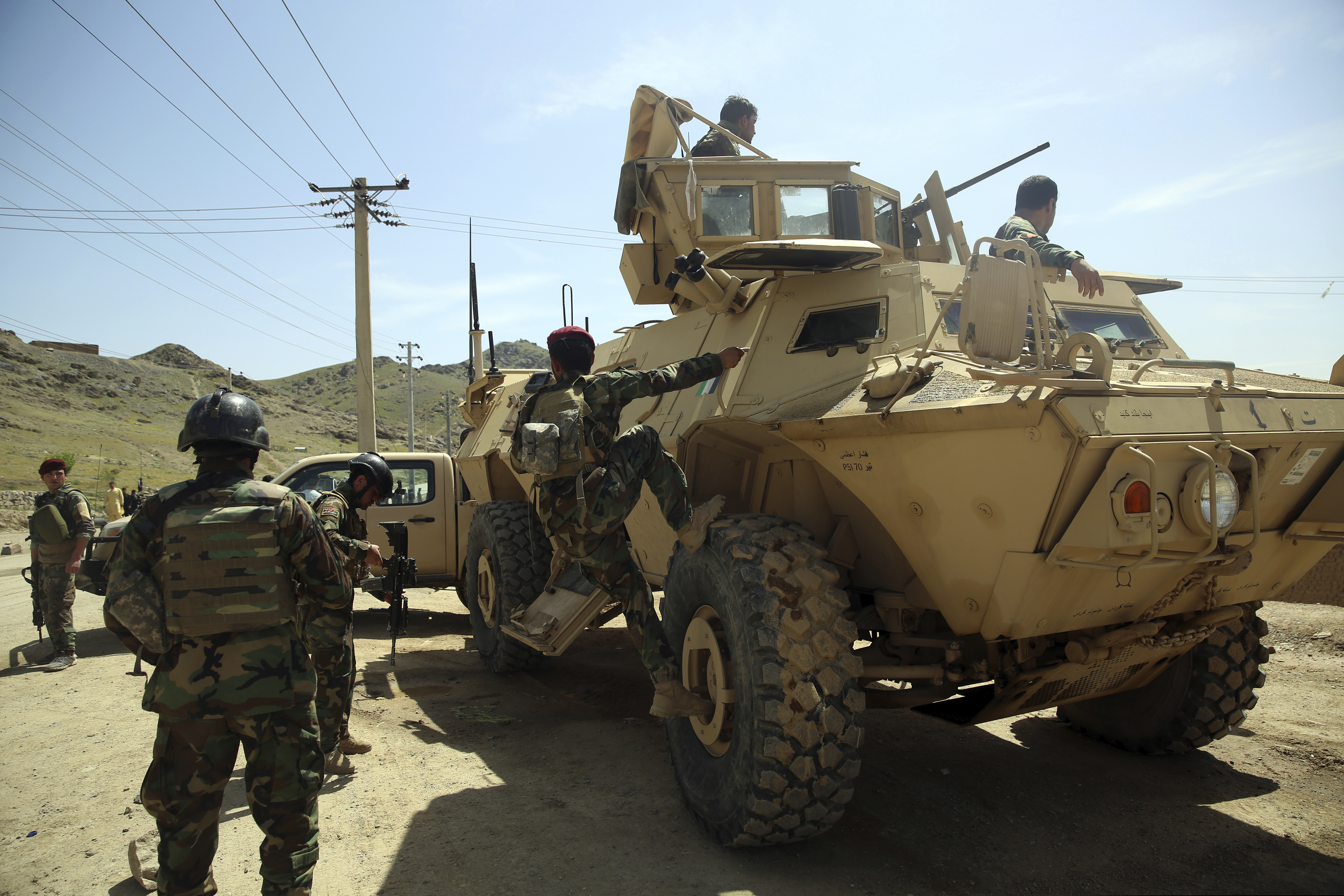 Afghan special forces stand guard at the site of a suicide bomber attack on the outskirts of Kabul, Afghanistan.