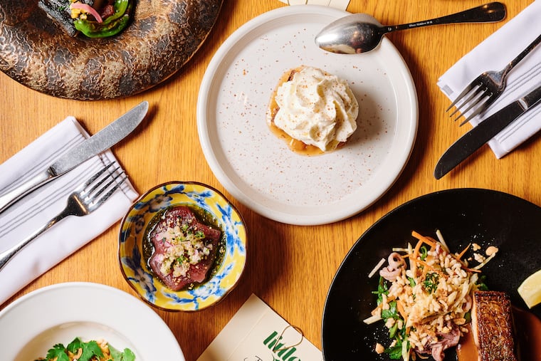 Table spread featuring a bigeye tuna crudo, shrimp and scallop, grilled black cod, pan seared red drum and tres leches cake from Little Fish on Friday, June 28, 2024, in Philadelphia .