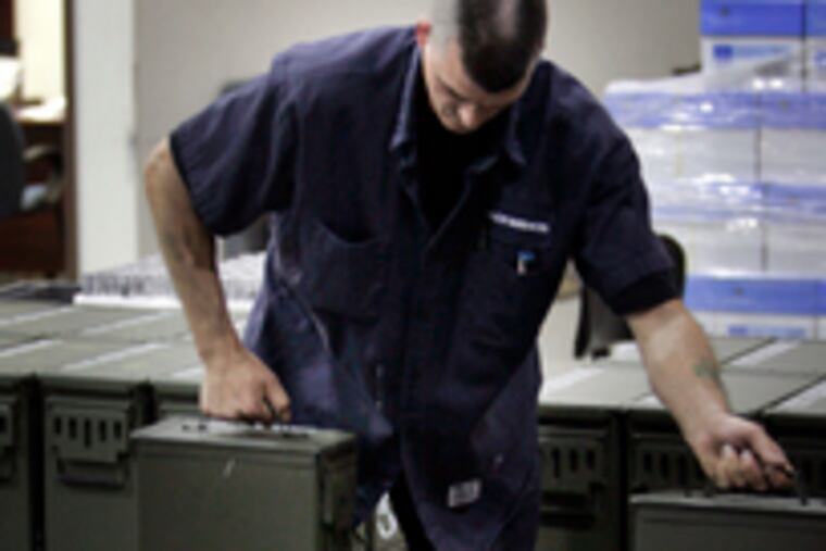 At Alloy Surfaces, which makes an expendable antimissile decoy, Frank McCarthy stacks ammo cans.