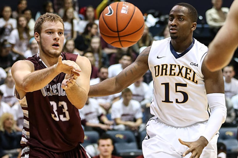 University of Sciences' Garret Kerr throws a pass in front of Drexel's Mohamed Bah during the 1st half at the Daskalakis Athletic Center in Philadelphia, Thursday December 4, 2014. (Steven M. Falk/Staff Photographer)