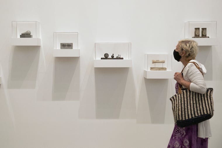 A masked visitor takes in a collection by American painter Jasper Johns at the Philadelphia Museum of Art on Thursday, Sept. 03, 2020. The museum reopened Thursday morning to members only after being closed due to the coronavirus. It will be open to the general public on Sunday.
