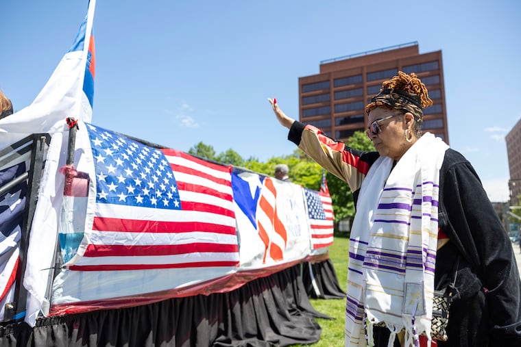 Gail Pryor, of North Philadelphia, Founder of You are the Key Crusades to Save a Life Inc., holds her hand up as a prayer is being spoken for the annual National Day of Prayer outside the Independence Visitor Center.