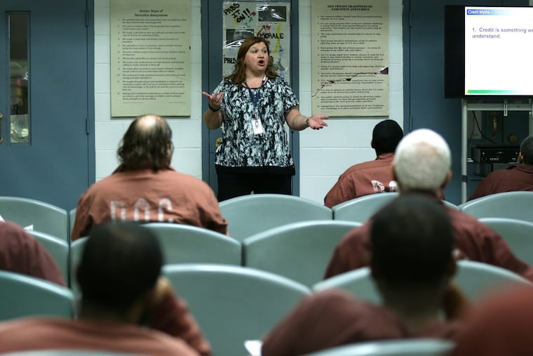 Becky MacDicken (center) educates inmates on financial literacy so they can re-enter society at the State Correctional Institution in Chester.