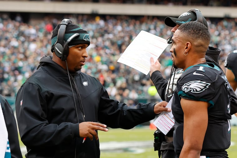 Eagles quarterbacks coach Brian Johnson with quarterback Jalen Hurts against the New Orleans Saints on Nov. 21 in Philadelphia.
