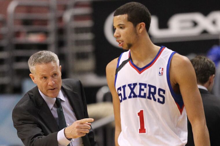 Sixers head coach Brett Brown and guard Michael Carter-Williams. (Yong Kim/Staff Photographer)