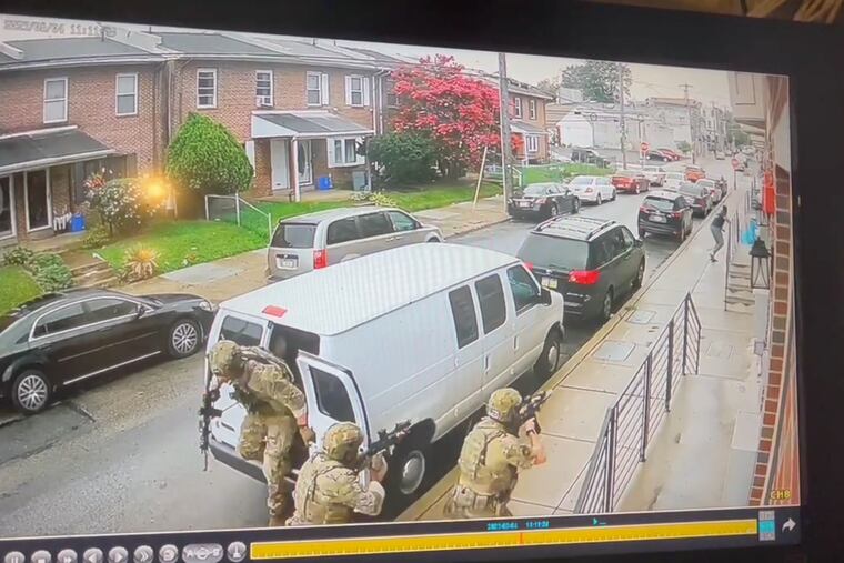 A still from surveillance footage shows an armed FBI SWAT team pursuing Tahiem Weeks-Cook moments before an agent shot him Friday near the intersection of 17th and West Venango Streets in Philadlephia's Nicetown-Tioga section.
