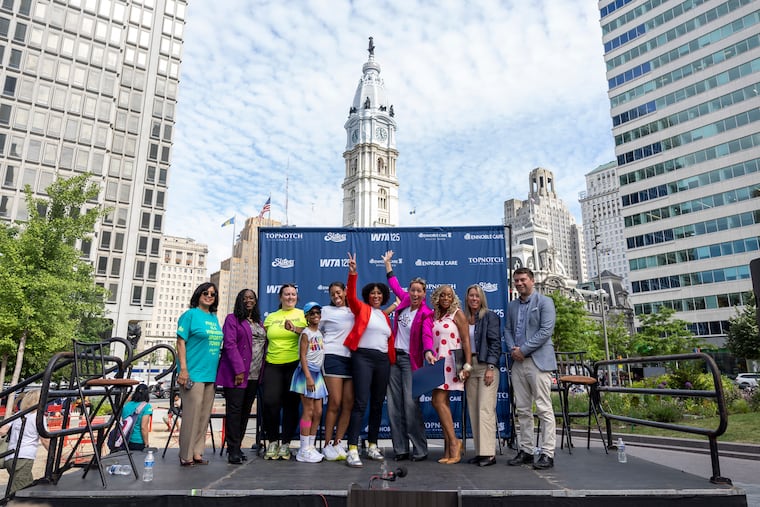 Alex Sykes (right center) and others involved in bringing the WTA to Philly later this year pose for a photo at Wednesday's launch party.