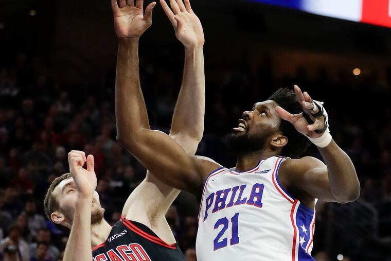 Joel Embiid is fouled by the Bulls' Luke Kornet.