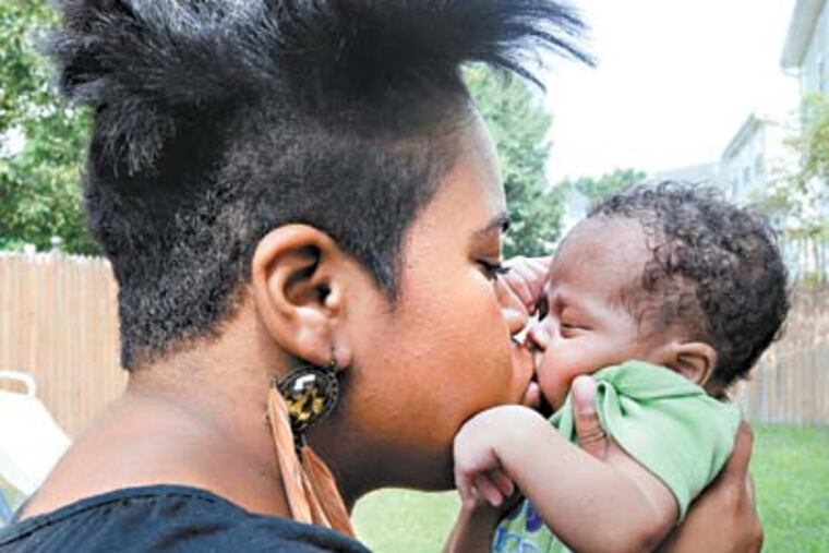 Shayna Stoney, 27, kisses Seff, 4 weeks old. Her husband, Sean, died of a heart attack at a young 28 years old. He leaves behind a wife and 5 young boys. ( SHARON GEKOSKI-KIMMEL / Staff Photographer )