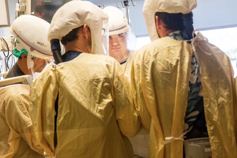 Registered Nurse Westin Prouty, center, and a medical team finish turning over a COVID-19 patient onto their stomach to help with breathing, inside the intensive care unit at Central Washington Hospital on Tuesday, Sept. 21, 2021. Proning, or turning a patient on their stomach for better breathing, takes a team of people. With staffing shortages, the hospital has trained staff in other departments to come help with this strenuous and time-consuming process. (Amanda Snyder/The Seattle Times/TNS)