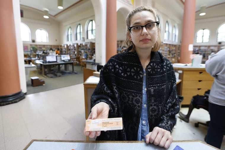 Chera Kowalski, who works at McPherson Square library, poses with naloxone inside the facility on a day last year when she had to use the reversal drug on a person who overdosed on heroin.