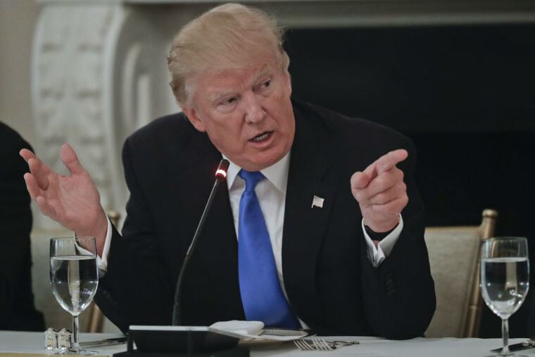 President Donald Trump points towards GOP Senators during a luncheon Wednesday as Republicans tried to revive their plans to repeal and replace the Affordable Care Act.