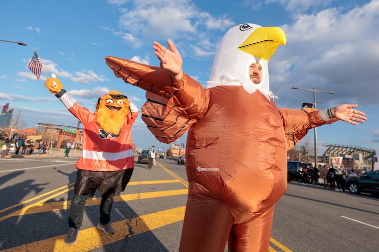 Protesters wear inflatable Gritty and eagle costumes as they rally ahead of President Donald Trump’s visit to NCAA wrestling at the Wells Fargo Center Saturday, March 22, 2025, in Philadelphia.