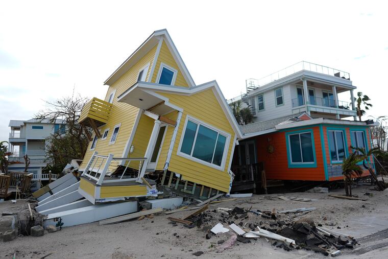 A house lies toppled off its stilts after the passage of Hurricane Milton, in Bradenton Beach on Anna Maria Island, Fla., on Thursday, Oct. 10, 2024.
