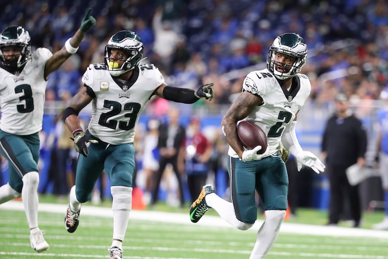 Eagles cornerback Darius Slay runs with the football for a fumble recovery touchdown with teammates cornerback Steven Nelson and safety Rodney McLeod in the third quarter against the Detroit Lions on Sunday, October 31, 2021 in Detroit.