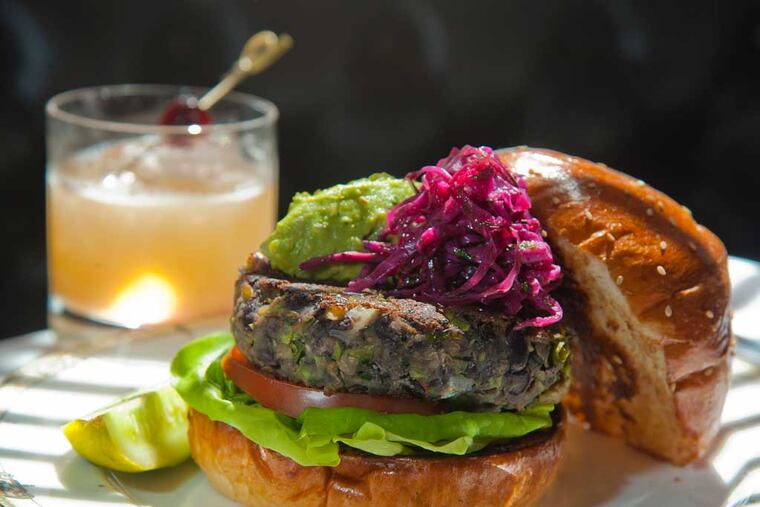 The Village Whiskey veggie burger is made from black beans and lentils, carrots, onions, peppers, corn edamames, Swiss chard, cilantro, toasted cumin and corander seed and a little turmeric. ( CLEM MURRAY / Staff Photographer )