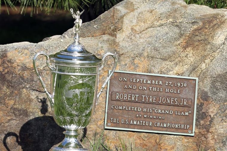 The Robert Jones plaque with the U.S. Open Trophy during the Preview Day at the par four 11th hole at Merion Golf Club East Course on Monday, April 22, 2013. The plaque commemorates Jones completing the "grand slam" of golf by winning the U.S. Amateur Championship on September 27, 1930. (Yong Kim/Staff Photographer)