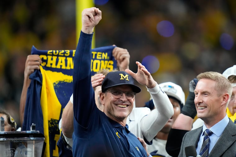 Michigan coach Jim Harbaugh celebrates after the Big Ten championship against Iowa. Michigan won, 26-0.