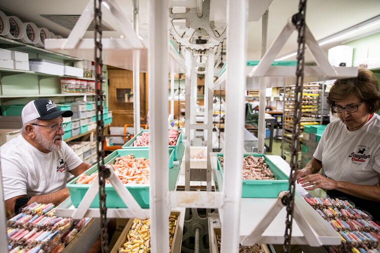 Production Assistants Jim Jacoby, 67, of Cape May Courthouse, N.J., and Barbara Burns, 67, of Cape May County, N.J., pack containers of salt water taffy at Douglas Candy in Wildwood, N.J., in mid-June.