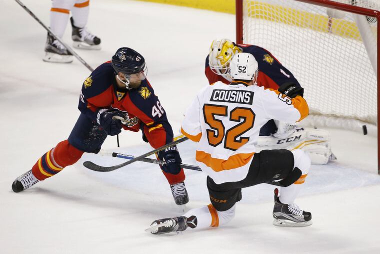 Flyers center Nick Cousins (52) scores against Florida Panthers goalie Roberto Luongo (1) and defenseman Jakub Kindl (46) during the first period.