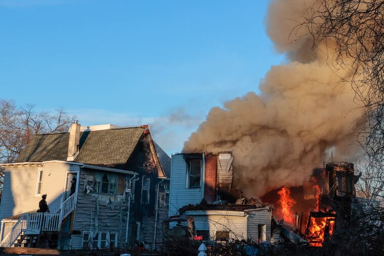 Firefighters battle a massive blaze that broke out late Wednesday at a home on Lewis Avenue in East Lansdowne. Delaware County officials said two officers, one from East Lansdowne and one from Lansdowne, were shot outside the home while responding to a call about the shooting of an 11-year-old girl inside.