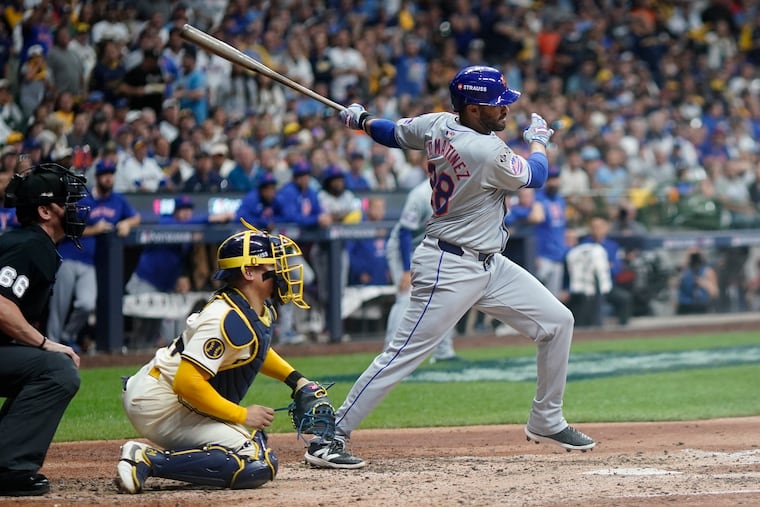 New York Mets' J.D. Martinez hits a two-run scoring single during the fifth inning of Game 1 of a National League wild card matchup with the Brewers.