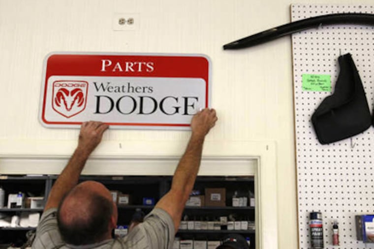 Larry Weathers III examines another sign that will have to be replaced. (Michael S. Wirtz / Staff Photographer)