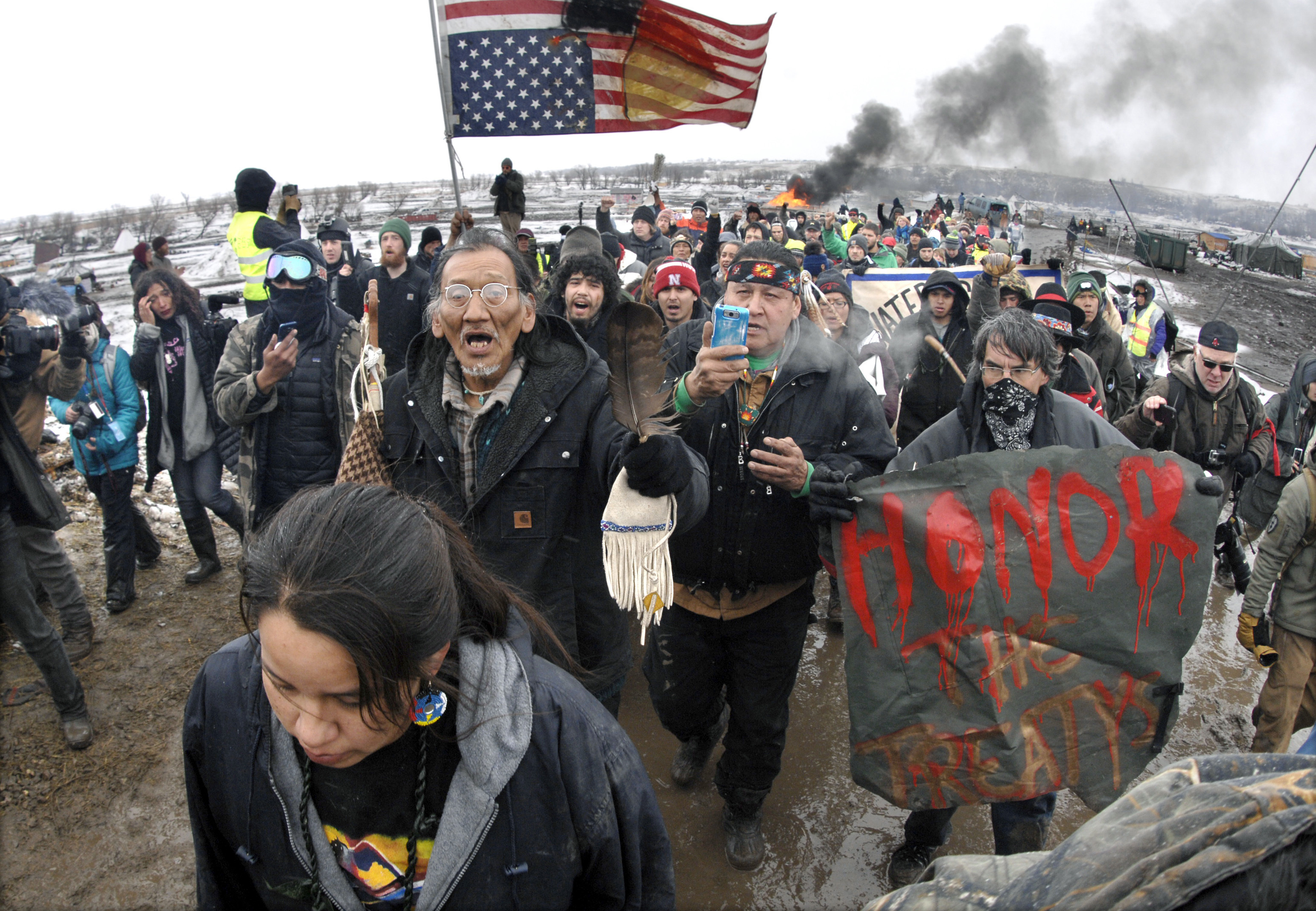 In this Feb. 22, 2017, file photo, a large crowd representing a majority of the remaining Dakota Access Pipeline protesters march out of the Oceti Sakowin camp before the deadline set for evacuation of the camp mandated by the U.S. Army Corps of Engineers near Cannon Ball, N.D.