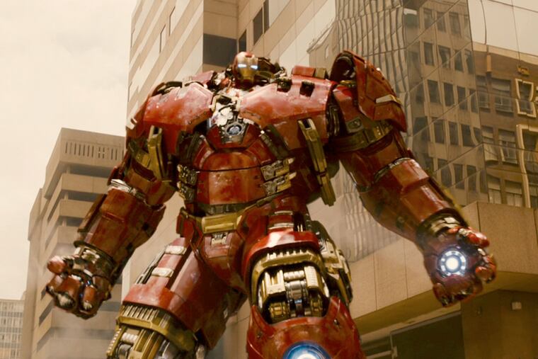 Joss Whedon directs the gang in a story about a Tony Stark (seen here in his "Hulk buster" Iron Man armor) A.I. program gone awry, threatening humanity.