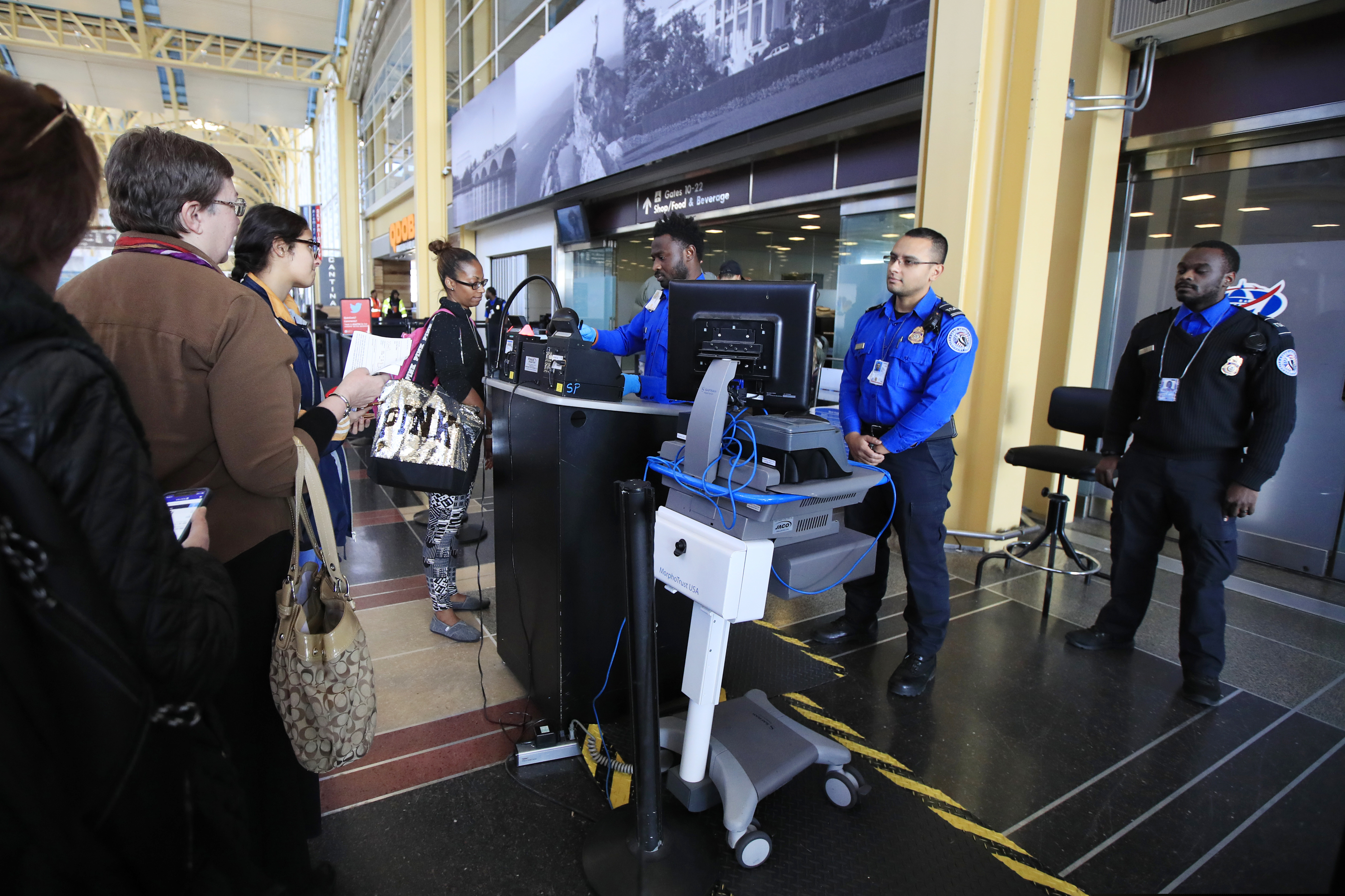 Transportation Security Administration (TSA) officers check and watch airline passengers at Reagan National Airport in Washington, Thursday, Dec. 27, 2018. TSA employees are working through the partial government shutdown without pay.