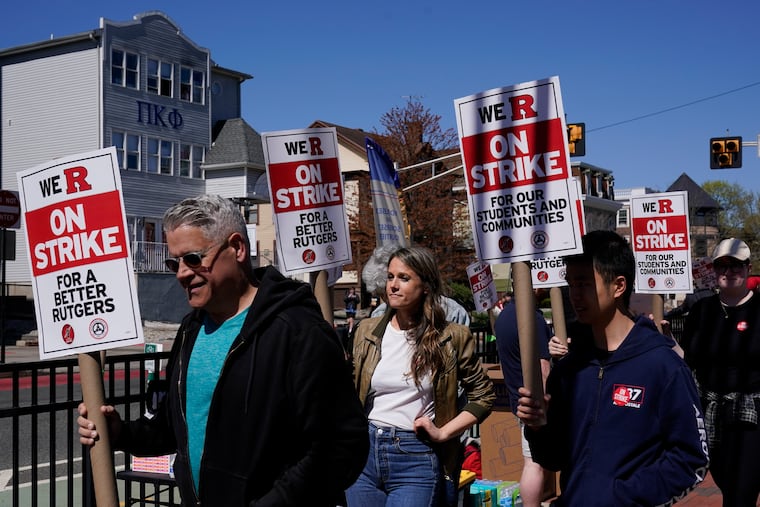 Strikers marching in front of Rutgers' buildings in New Brunswick, N.J., Monday, April 10, 2023.