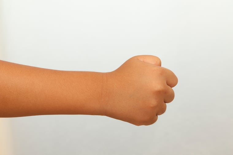 Child's fist, white background