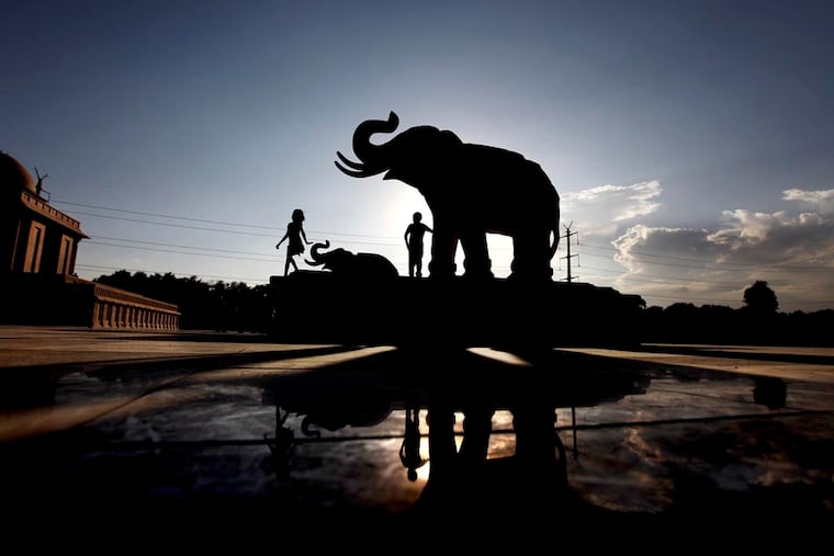 Indian children play next to an elephant statue at Ambedkar Park, dedicated to Dalits or India’s low-castes, which was opened to the public in Noida, on the outskirts of New Delhi, India. Dalit engineers and advocates say that tech companies don't understand caste bias and have not explicitly prohibited caste-based discrimination.