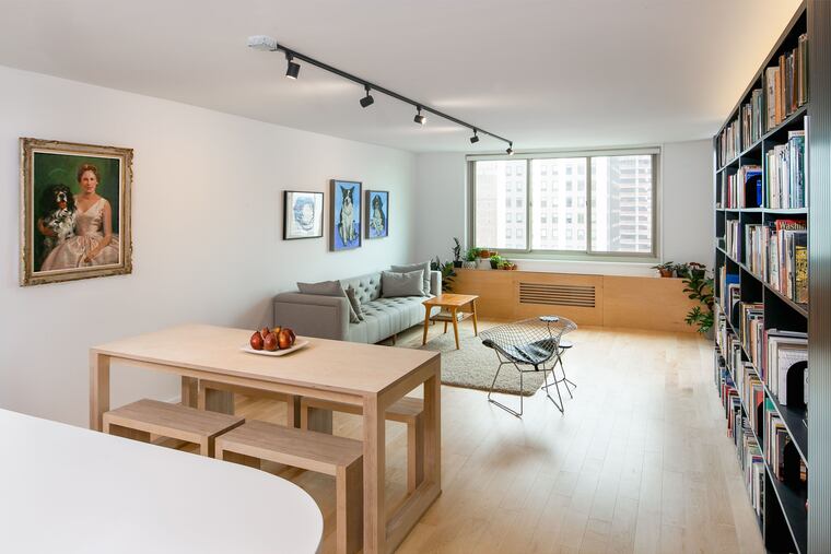 A floor-to-ceiling bookcase helps define space in this Center City Philadelphia apartment.