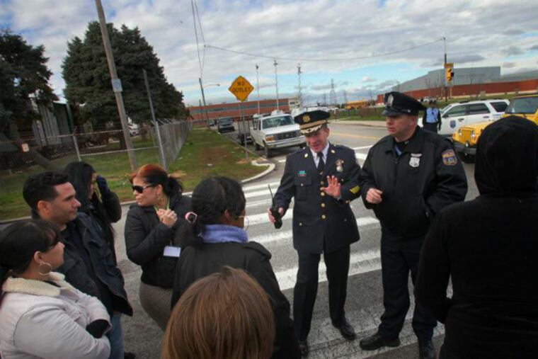 Chief Inspector Dennis Wilson speaks with concerned parents at Fels High School about gun investigation on school grounds.