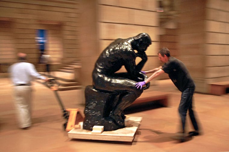 "The Thinker" is a blur as the famous Auguste Rodin sculpture is wheeled through the Philadelphia Museum of Art's Great Stair Hall earlier today on its way to a temporary home in the museum renovations at the nearby Rodin Museum.