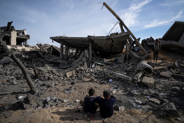 Palestinians look at the damage Monday to residential buildings where two Israeli hostages were reportedly held before being rescued during an operation by Israeli security forces in Rafah, southern Gaza Strip.
