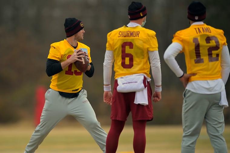 Garrett Gilbert drops back to throw as Kyle Shurmur and Jordan Ta'amu watch at a Washington Football Team practice Sunday.