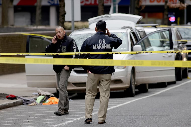 U.S. Marshals gather at the scene of a shooting by a security officer.