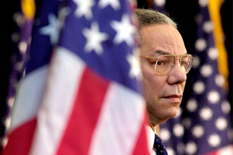 In this Feb. 15, 2001 photo, Secretary of State Colin Powell looked on as President Bush addressed State Department employees at the State Department in Washington.